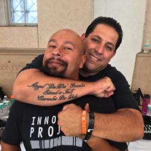 Angel Gonzalez (left) with his friend, volunteering at an Innocence Project event in summer of 2016.